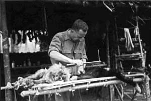 Adolph H. Schultz measuring to freshly hunted gibbons near Chiengmai